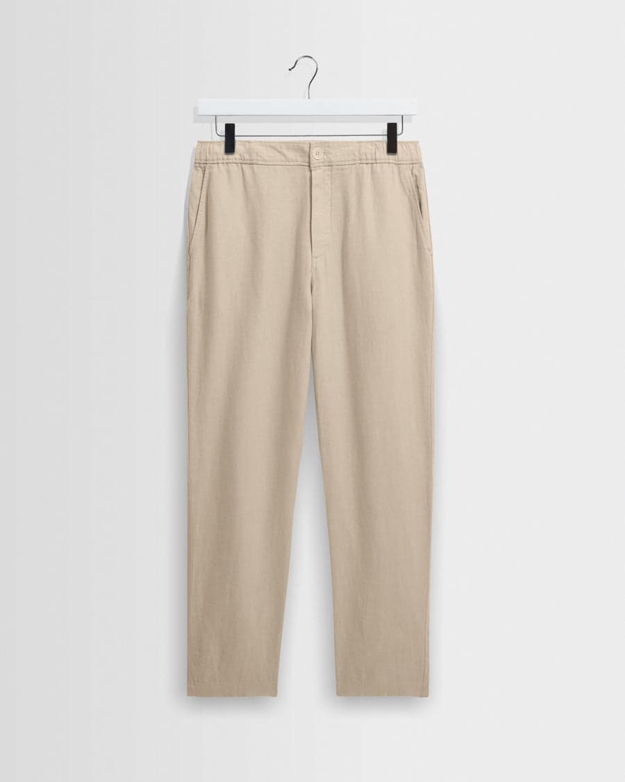 A pair of beige washed-linen relaxed-fit trousers — an easy warm-weather staple
