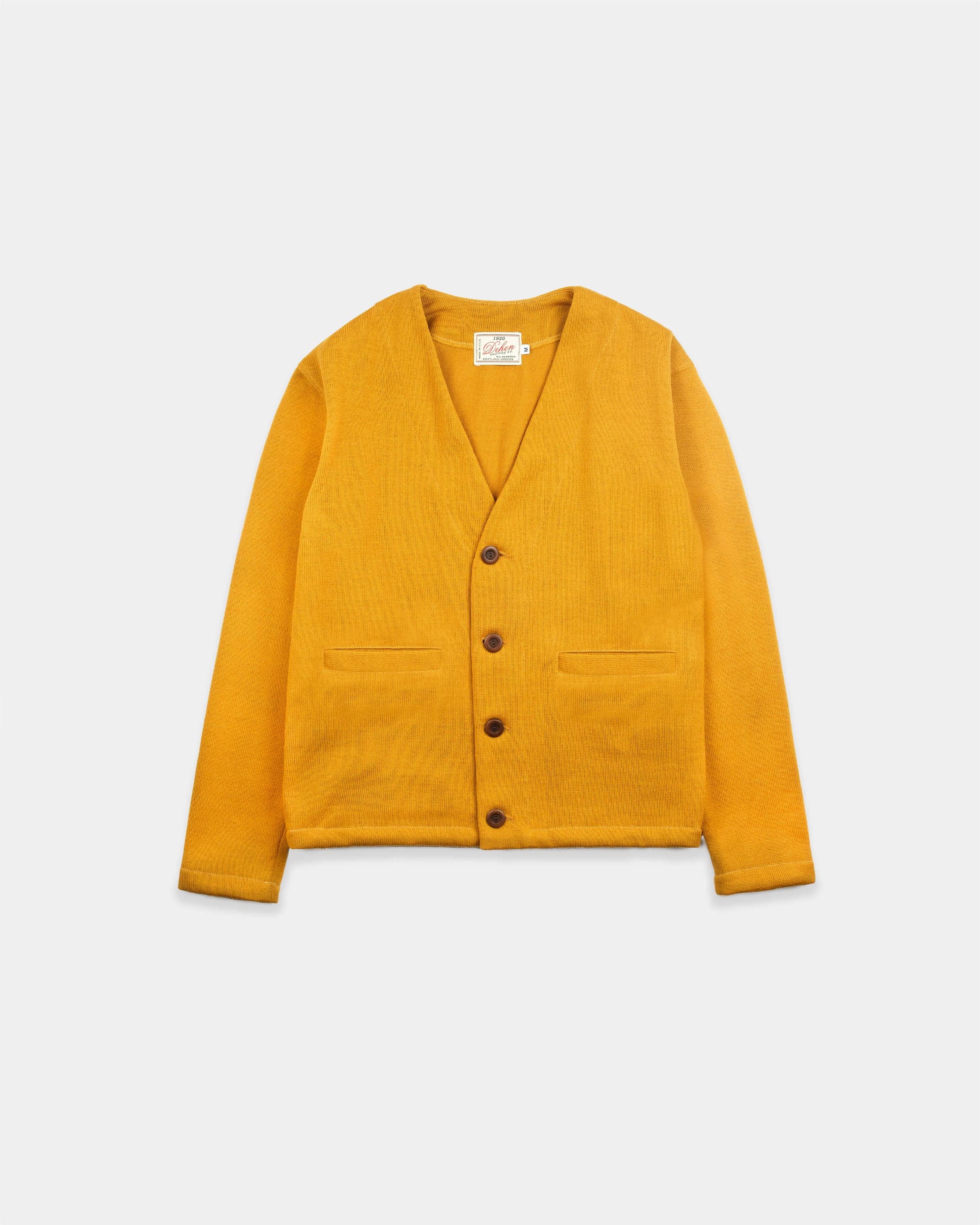 An old-gold slouchy cardigan — the cardigan silhouette this guide ranks