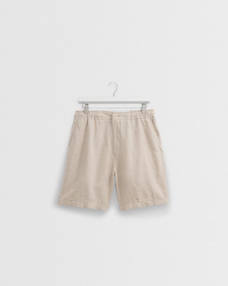 A pair of beige washed-linen shorts — a lightweight warm-weather staple