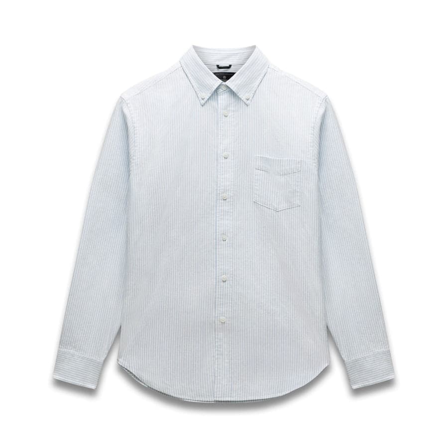 A light-blue striped Oxford shirt — the kind of clean everyday basic a Uniqlo capsule is built on