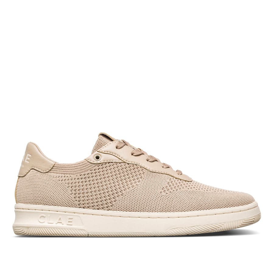 A clean cream knit sneaker — the kind of quiet, comfortable staple a 50+ capsule leans on