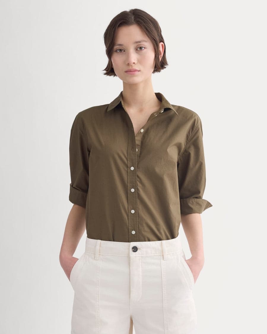 An olive cotton shirt with cream trousers — clean, proportion-friendly separates